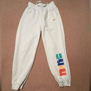 Nike Optimism White Sweatpants Size Medium with the colorful ABC Swoosh logo